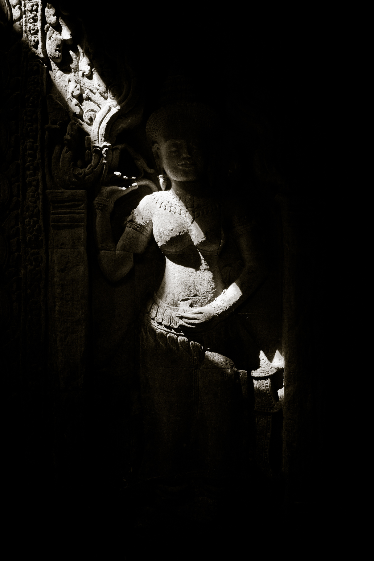 Sunbeams on statue. Preah Khan, Angkor, Cambodia. January 2012